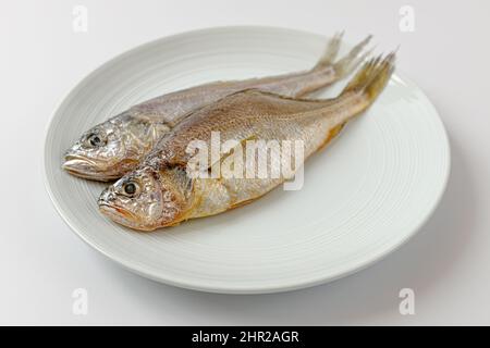 dried yellow croaker on a white background Stock Photo