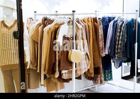 Collection of casual multicolored clothes in a fashion boutique. Selective blurred focus. Stock Photo