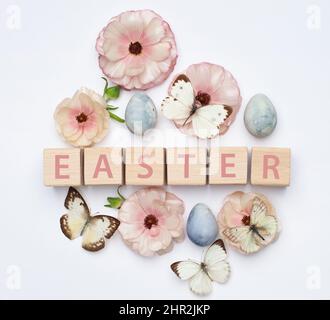 Spring flowers and Easter eggs painted in blue color. Flat lay, top view Stock Photo