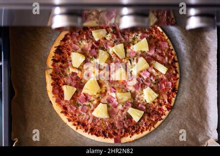 Hawaiian pizza in the oven Stock Photo