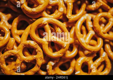 A closeup shot of organic brown mini Pretzels with salt under the light in the studio Stock Photo