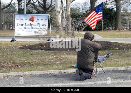 An unidentified man prays at the Vatican Pavilion site in Flushing Meadows park where Mary & Jesus appeared to Veronica Lueken. In Queens, NYC. Stock Photo