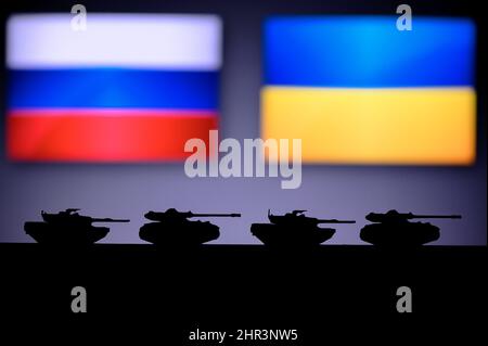 War in Ukraine. Russia attack Ukraine. Illustration Photo. Silhouette of Tanks, National Flag in Background. Conflict in Europe Stock Photo
