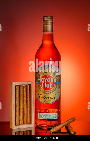 Bottle of cuban rum with cigars on orange background. Advertising shooting. Moscow Russia February 21, 2022. Stock Photo