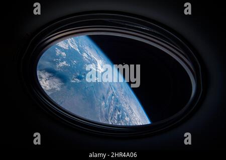 Porthole of spaceship in the outer space, blue earth planet and moon, bull's-eye window view from spacecraft. Elements of this image furnished by NASA Stock Photo
