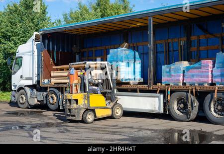 SAINT PETERSBURG, RUSSIA - SEPTEMBER 10, 2021: Loading of a truck with construction goods Stock Photo