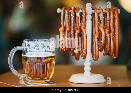 Salted soft pretzels and beer on the table in the bar Stock Photo