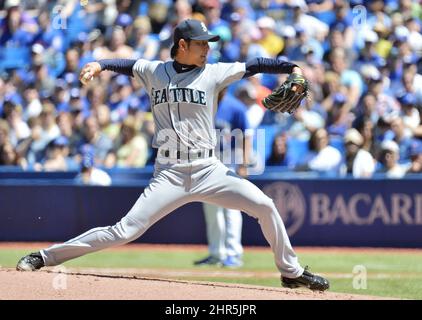 Seattle Mariners' Hisashi Iwakuma gives a kiss to his son Towa after the  child was among several players' children throwing out the ceremonial first  pitch on Father's Day before a baseball game