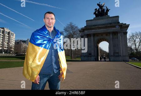 25 FEB 2022 - RUSSIA INVASION - Vladimir Klitschko in London, Britain  FILE PHOTO  Former World Heavyweight Boxing Champion Vladimir Klitschko shows his true colours as he proudly wears the Ukranian flag in front of Wellington Arch in central London. This image was taken on 24th February 2014. Exactly 8 years later to the day Russia would invade Ukraine.  Vladimir is the brother of Vitali Klitschko who is the Mayor Of Kyiv, Ukraine.   Picture : Mark Pain / Alamy Live News Stock Photo