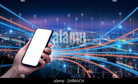 Male hand holding smartphone with blank screen and Smart connection network system background, smart city network concept, 5G wireless connection. Stock Photo