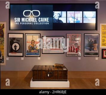 Bonhams, London, UK. 25 February 2022. Sir Michael Caine: The Personal Collection preview before sale on 2 March 2022. He and his wife, Lady Caine, are downsizing and have put some of their treasured possessions up for auction. Image: signed posters from his many film roles. Credit: Malcolm Park/Alamy Live News Stock Photo