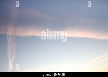 Traces of planes in the sky, exhaust fumes in nice lines on a blue background. Airplane traces. Stock Photo