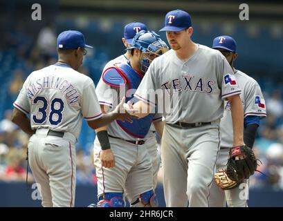 Texas Rangers manager Ron Washington, front right, greets Adrian