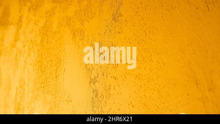 Golden wall plaster close-up. Decorative Venetian plaster. Stock Photo
