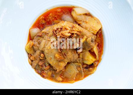 Massaman pork curry on wood background. Thai coconut milk curry. Stock Photo