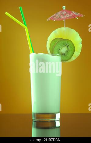 Milk shake  with chocolate and fruit on yellow background Stock Photo