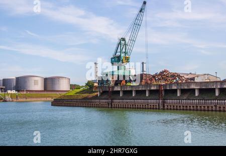 A crane at a scrap yard in the Cologne harbor industrial area NRW Germany Europe Stock Photo