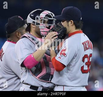Boston Red Sox catcher Sandy Leon (3), left, wearing pink nail polish, speaks with Boston Red Sox relief pitcher Junichi Tazawa (36) during the 7th inning of AL baseball action between Toronto and Boston in Toronto on Sunday, May 10, 2015. THE CANADIAN PRESS/Peter Power Stock Photo