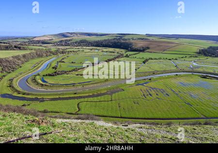 Brighton UK 25th February 2022 - Views over the River Cuckmere and valley below near Alfriston , Sussex on a beautiful sunny day : Credit Simon Dack / Alamy Live News Stock Photo