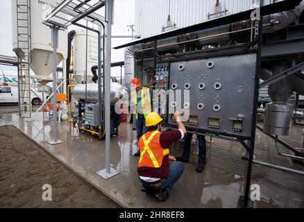 Workers calibrate equipment at Calgary-based Carbon Engineering's first direct air capture plant in Squamish, B.C., on Wednesday October 7, 2015. The plant extracts carbon dioxide directly from atmospheric air in a closed-loop industrial process. A pellet reactor system is used to take the carbon dioxide that has been absorbed from the air into liquid in an air contractor and transform it into a solid pellet which can be dried and moved to a calciner for carbon dioxide release and purification. THE CANADIAN PRESS/Darryl Dyck Stock Photo