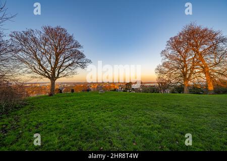 Trees and the view towards Essex from Windmill hill Gravesend Kent at Sunset on a winters evening Stock Photo