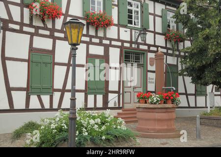 Local history museum and a fountain in front of it, Ginsheim, Hesse, Germany Stock Photo