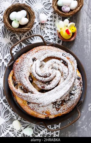 Easter cake with zest and dried fruits and Easter decor on a light background. Stock Photo