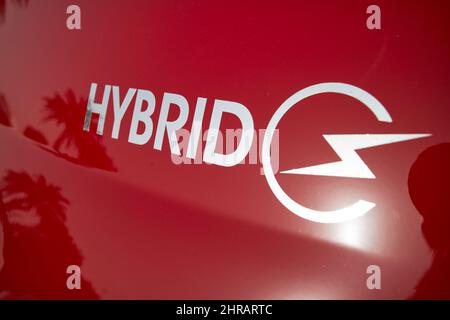 hybrid symbol on a red hire car Lanzarote, Canary Islands, Spain Stock Photo