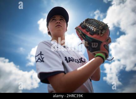 Pitcher Claire Eccles, 19, sports a tattoo of a baseball behind her right  ear as she