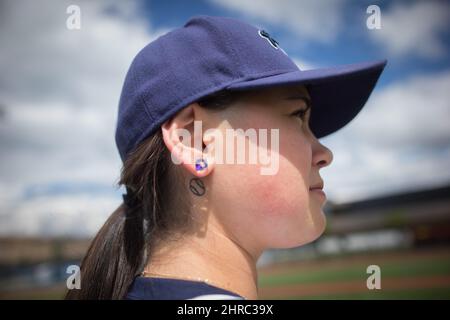 Pitcher Claire Eccles, 19, sports a tattoo of a baseball behind her right  ear as she