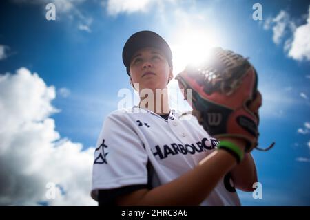 Pitcher Claire Eccles, 19, sports a tattoo of a baseball behind her right  ear as she