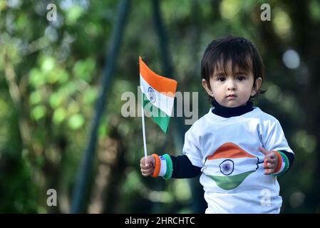 An adorable proud Indian child with an Indian flag and flag shirt Stock Photo