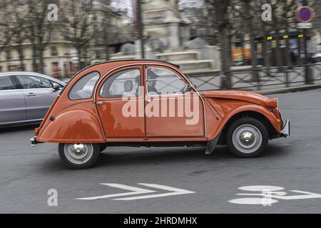 Classic red  colored Citroen 2CV car driving on the street Stock Photo