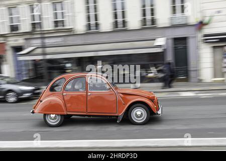 Classic red  colored Citroen 2CV car driving on the street Stock Photo