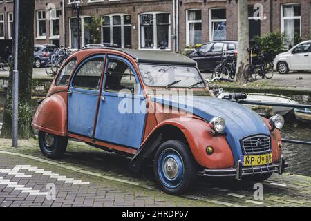 Classic red and blue colored Citroen 2CV car on the street Stock Photo