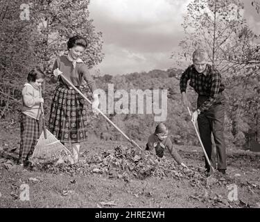 1960s FAMILY MAN FATHER WOMAN MOTHER TWO GIRLS DAUGHTERS WORKING TOGETHER RAKING AUTUMN LEAVES IN HOME YARD - j10213 HAR001 HARS PAIR 4 LEAVES SUBURBAN MOTHERS OLD TIME NOSTALGIA OLD FASHION SISTER 1 FITNESS JUVENILE YARD HEALTHY TEAMWORK FAMILIES LIFESTYLE SATISFACTION FEMALES HOUSES MARRIED RURAL SPOUSE HUSBANDS RAKE HEALTHINESS HOME LIFE NATURE COPY SPACE FULL-LENGTH LADIES PHYSICAL FITNESS DAUGHTERS PERSONS RESIDENTIAL RAKING MALES BUILDINGS SIBLINGS SISTERS FATHERS B&W PARTNER WIDE ANGLE ACTIVITY HAPPINESS PHYSICAL WELLNESS CHORE LEISURE STRENGTH AND DADS RECREATION FALL SEASON PRIDE Stock Photo