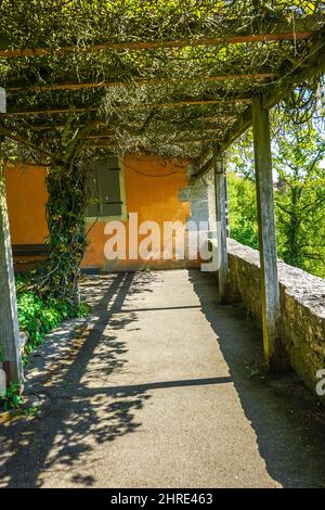 Wooden logs over a pathway against a building Stock Photo