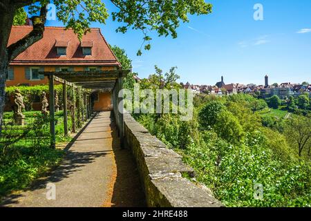 Wooden logs over a pathway against a building Stock Photo