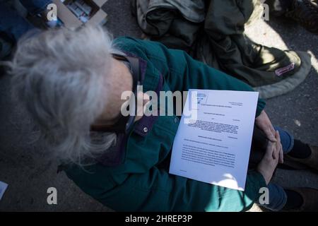 A copy of a court order left on a woman by RCMP officers is seen as protesters block a gate outside Kinder Morgan before RCMP officers moved in and arrested them for defying the court order, in Burnaby, B.C., on Saturday March 17, 2018. Approximately 30 people who blockaded an entrance - defying a court order - were arrested while protesting the Kinder Morgan Trans Mountain pipeline expansion. The pipeline is set to increase the capacity of oil products flowing from Alberta to the B.C. coast to 890,000 barrels from 300,000 barrels. THE CANADIAN PRESS/Darryl Dyck