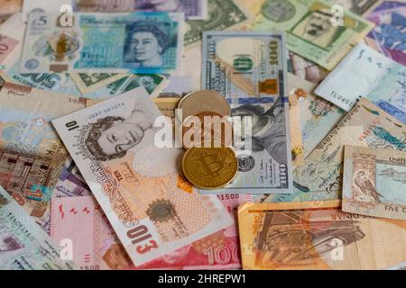 Worldwide banknotes and cryptocurrency digital payment system Stock Photo