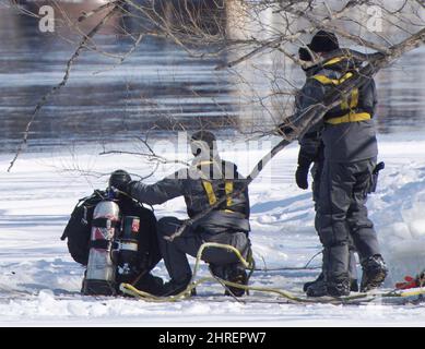 Police divers search the shores of the Riviere des Prairies on Montreal's north shore, Monday, March 19, 2018. Montreal police say they believe a boy who has been missing for 10 days more than likely fell into a river. THE CANADIAN PRESS/Ryan Remiorz Stock Photo