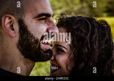Close-up portrait of a young happy Hispanic couple laughing Stock Photo