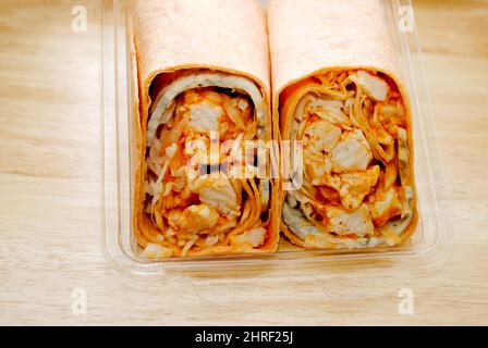 A Cut in Half Hot and Spicy Buffalo Chicken Wrap in a Plastic Package Stock Photo