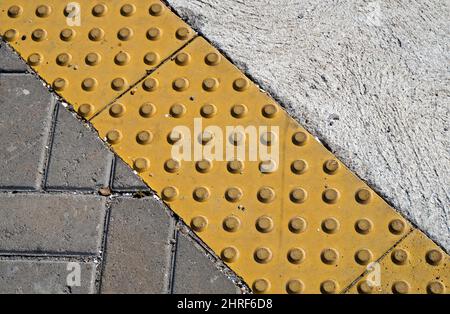 Warning bumps for blind people on sidewalk Stock Photo