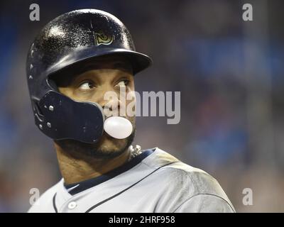 Seattle Mariners' Robinson Cano blows a bubble with his gum as he rounds  the bases after hitting a solo home run during the first inning of a  baseball game against the Cleveland