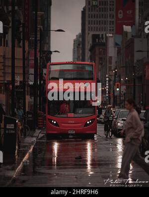 Double decker bus in downtown Toronto, Canada on a rainy evening Stock Photo