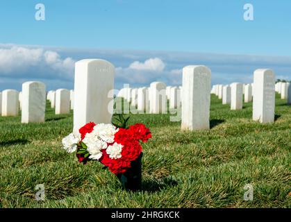 Shot of Headstones at Fort Rosecrans National Cemetery with the ocean in the background Stock Photo