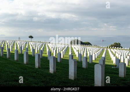 Shot of Headstones at Fort Rosecrans National Cemetery with the ocean in the background Stock Photo