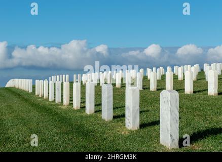 Shot of Headstones at Fort Rosecrans National Cemetery with the ocean in the background Stock Photo