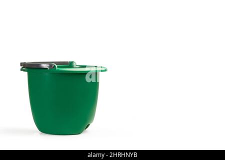 A green cleaning bucket on a white background with copy space Stock Photo